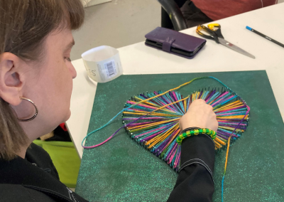 young lady completing string art project